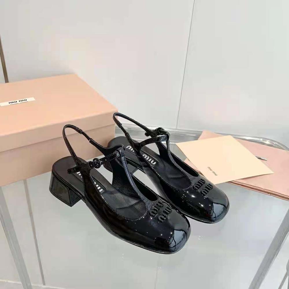 Rear angle showing adjustable strap on Miu Miu black patent pumps