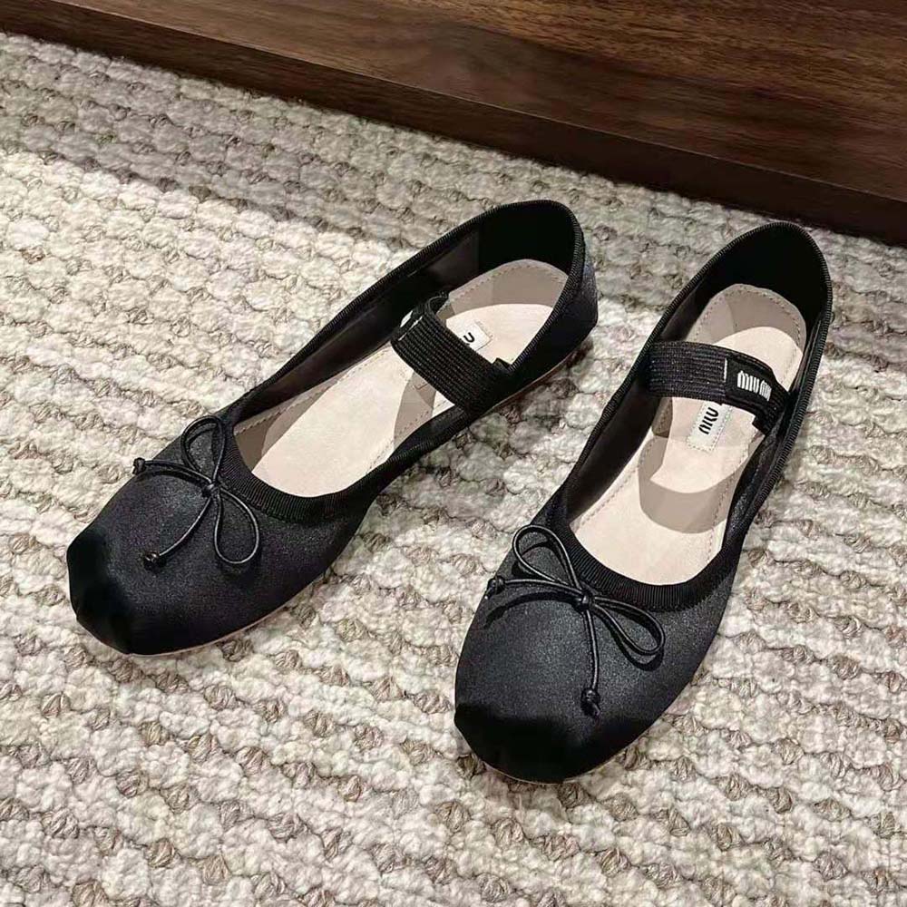 Close-up of knit logo label on Miu Miu Satin Ballerinas black