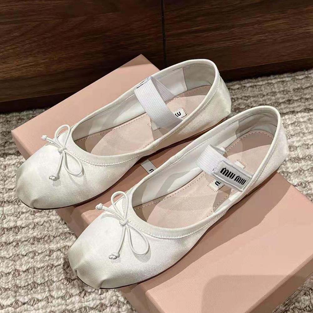 Overhead shot showing satin texture and silhouette of Miu Miu ballerinas