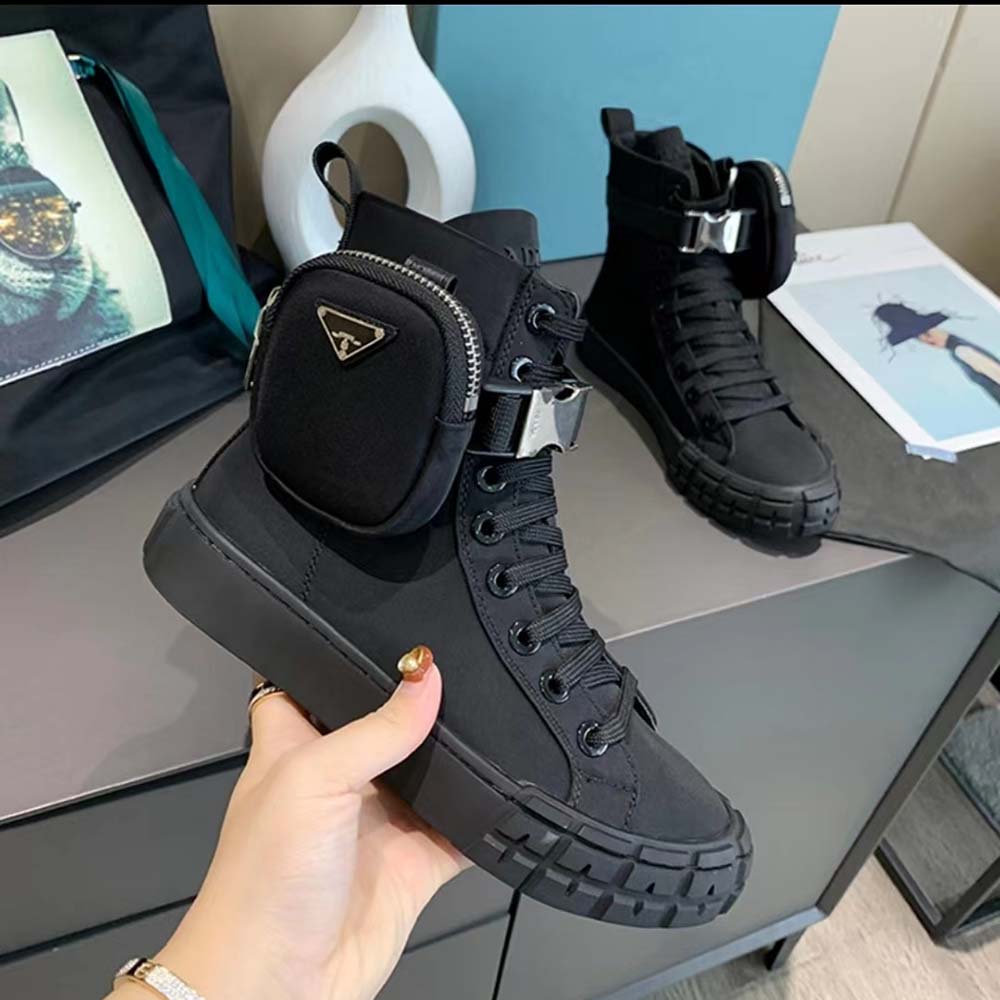 Close-up of Prada logo on black Re-Nylon high-top sneaker tongue