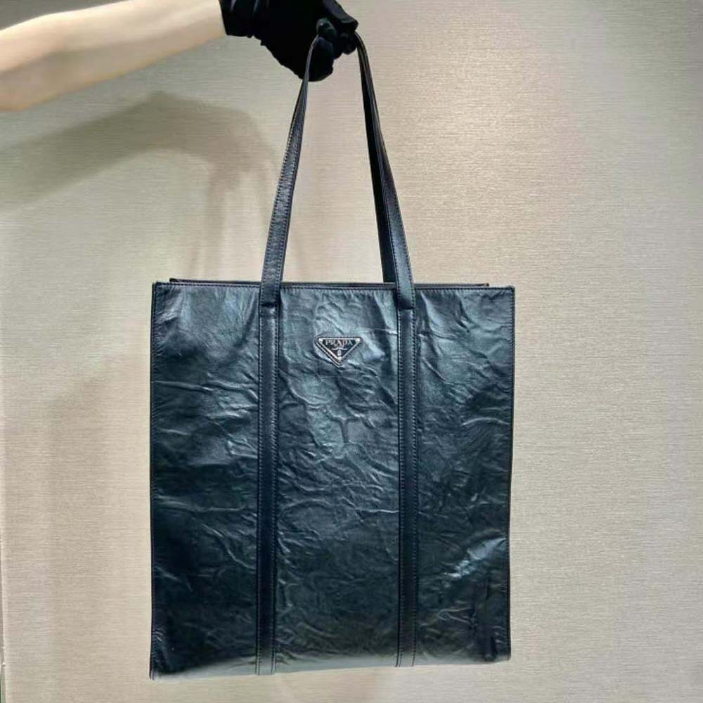 Close-up of silver-tone hardware on Prada Women Medium Antiqued Nappa Leather Tote Bag-Black