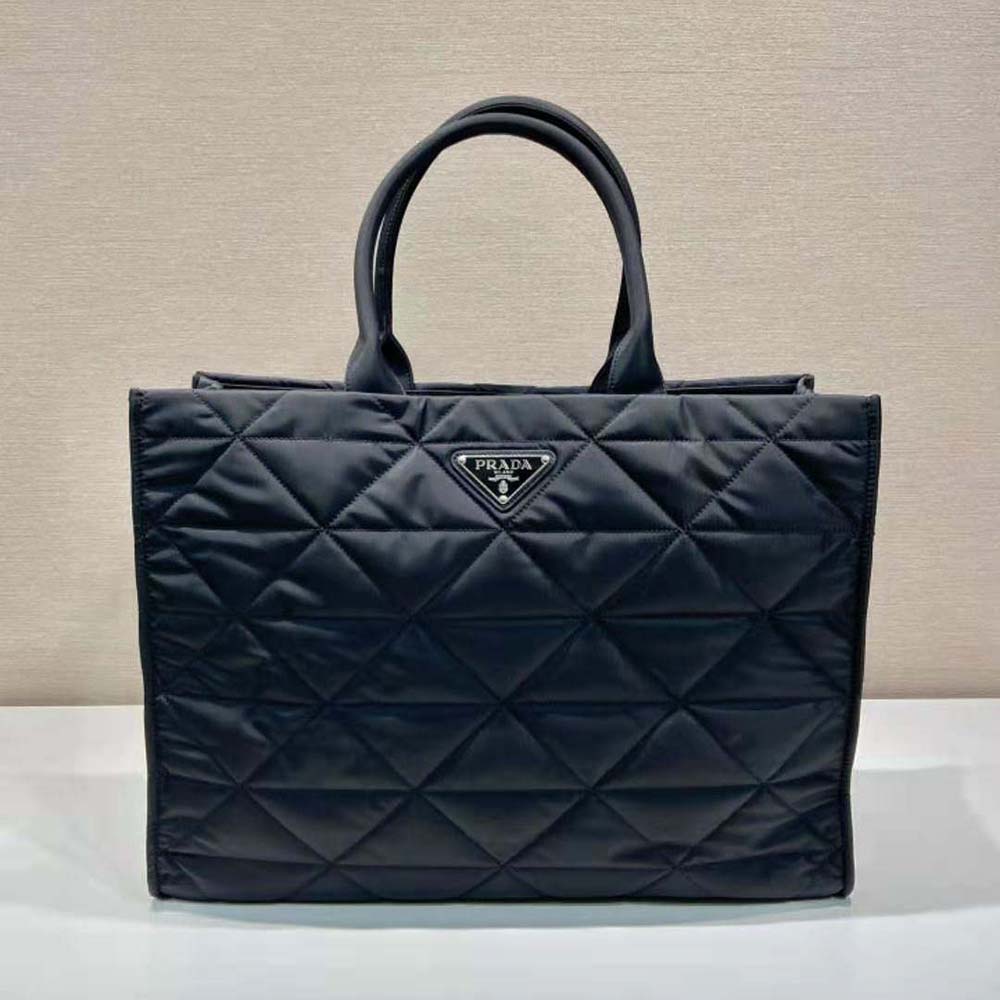 Close-up of silver hardware and tonal topstitching on Prada shopping bag