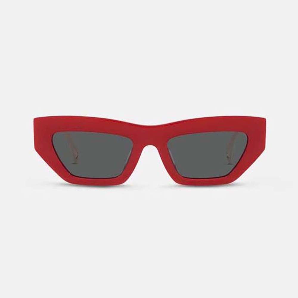 Close-up on gold Medusa logo detail on Versace red cat-eye sunglasses