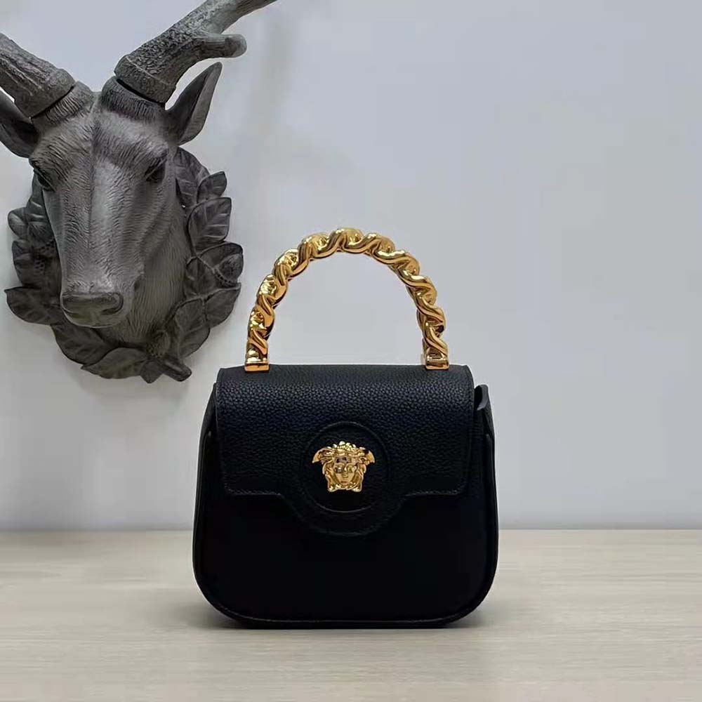 Close-up detail of the black leather and Medusa emblem on Versace Women La Medusa Mini Bag-Black