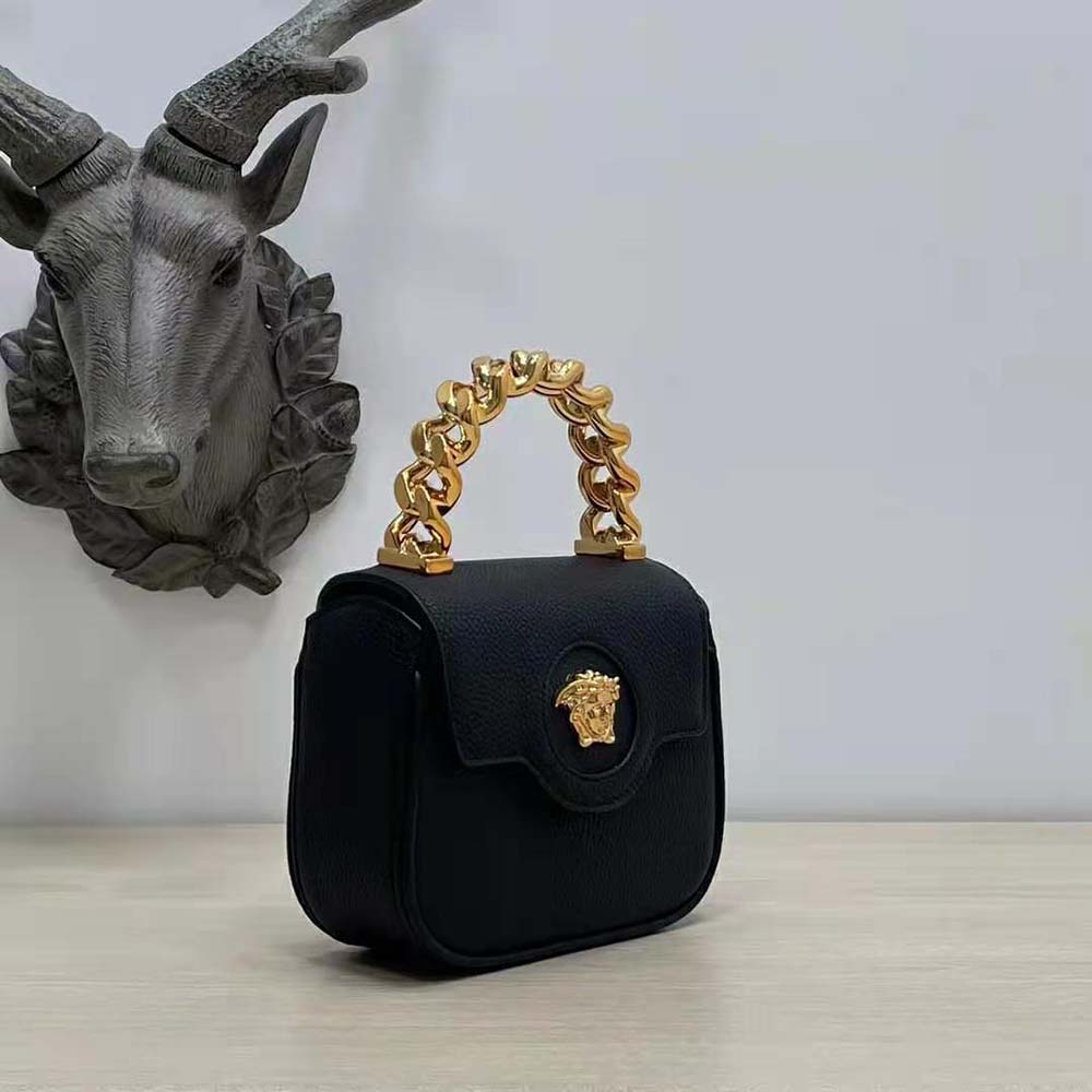 Side angle showing flap closure and adjustable strap of Versace Women La Medusa Mini Bag-Black