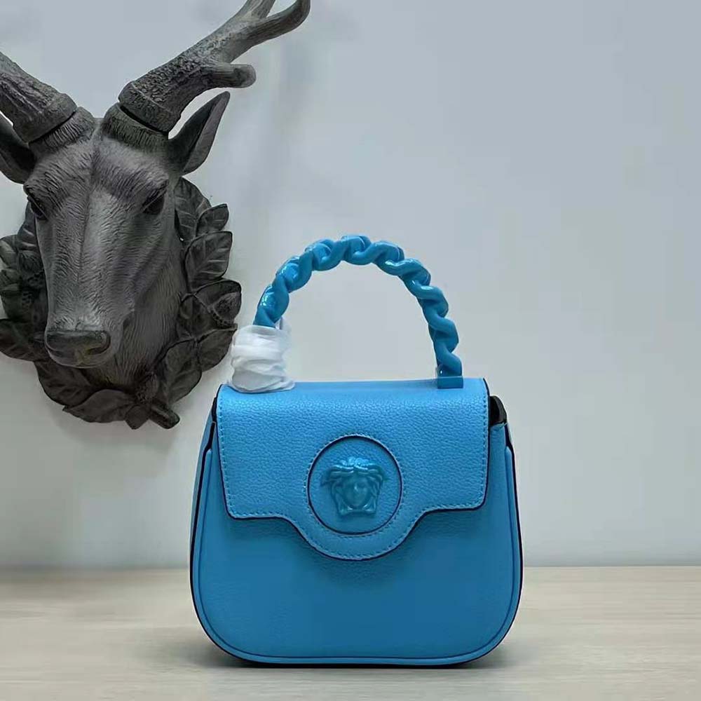Close-up of gold Medusa head detail on Versace Women La Medusa Mini Bag-Blue
