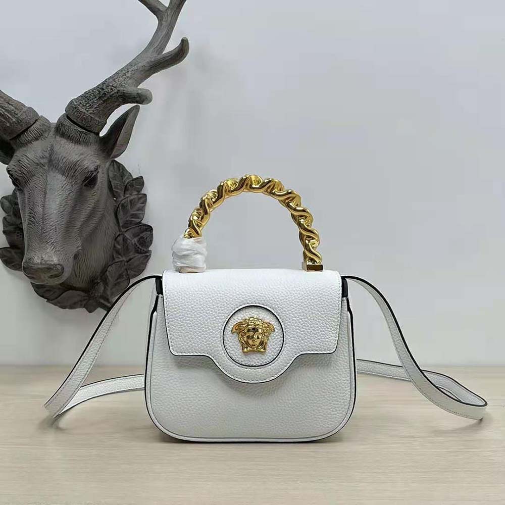 Side angle showing smooth white leather and adjustable strap of Versace Women La Medusa Mini Bag-White