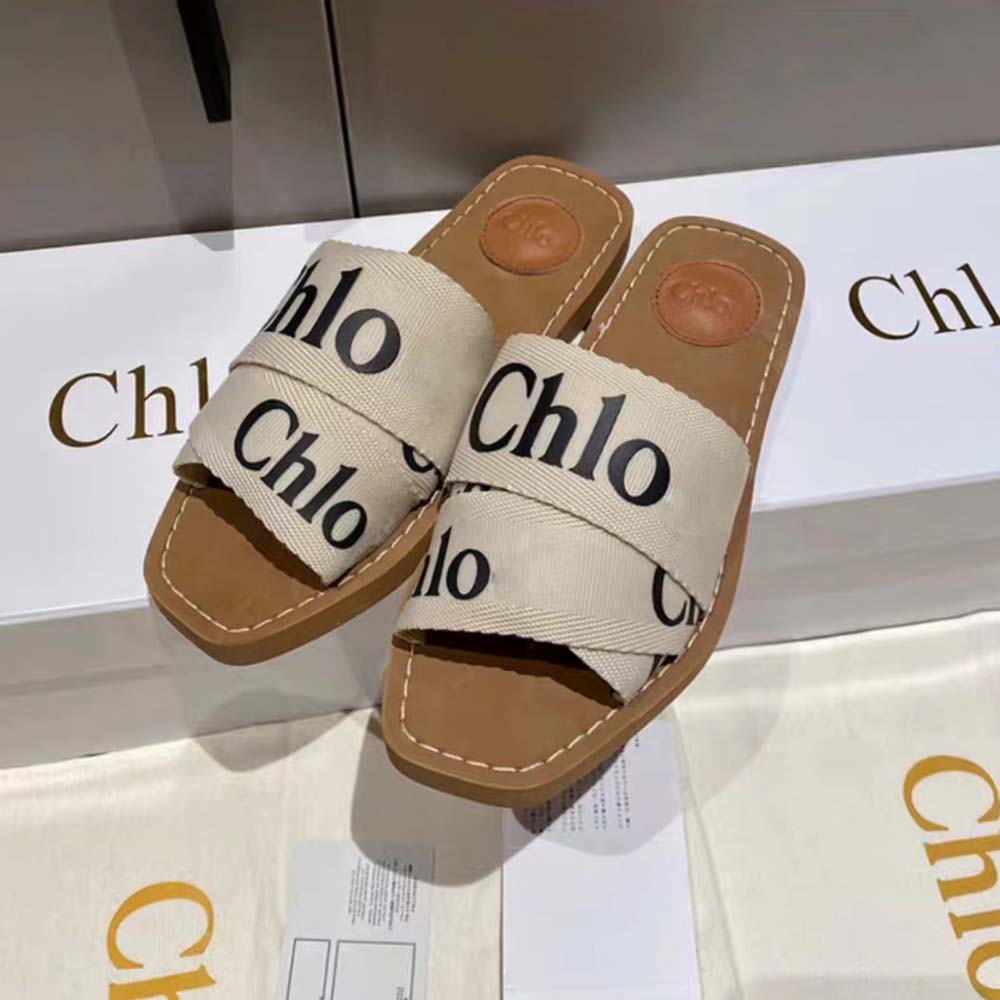 Close-up detail of beige canvas and signature heel on Chloe Women Woody Flat Mule