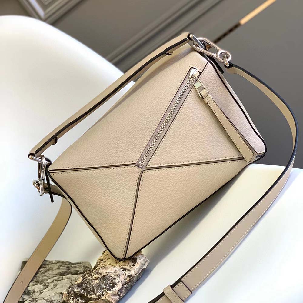Side angle showing adjustable strap and zipper of Loewe Puzzle Bag