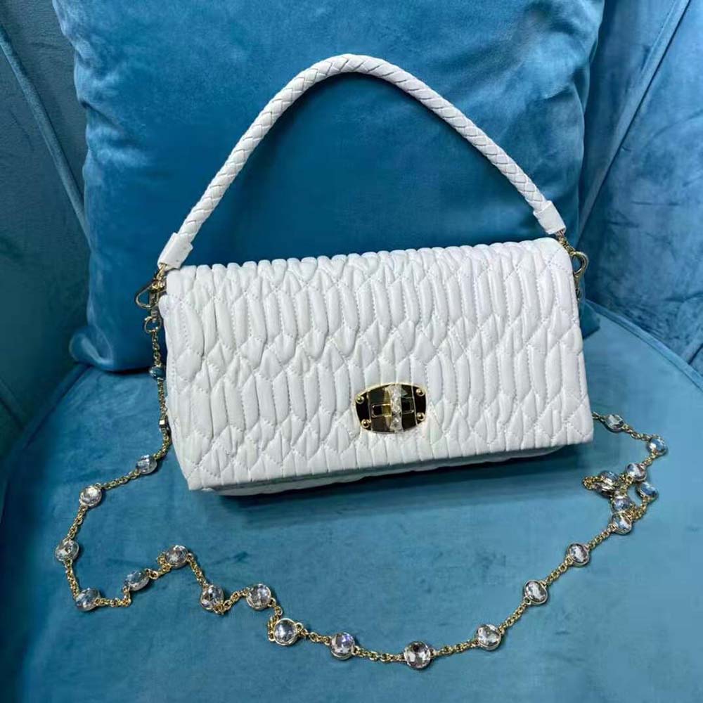 Side angle showing silver hardware and cloqué texture on Miu Miu Women Crystal Bag