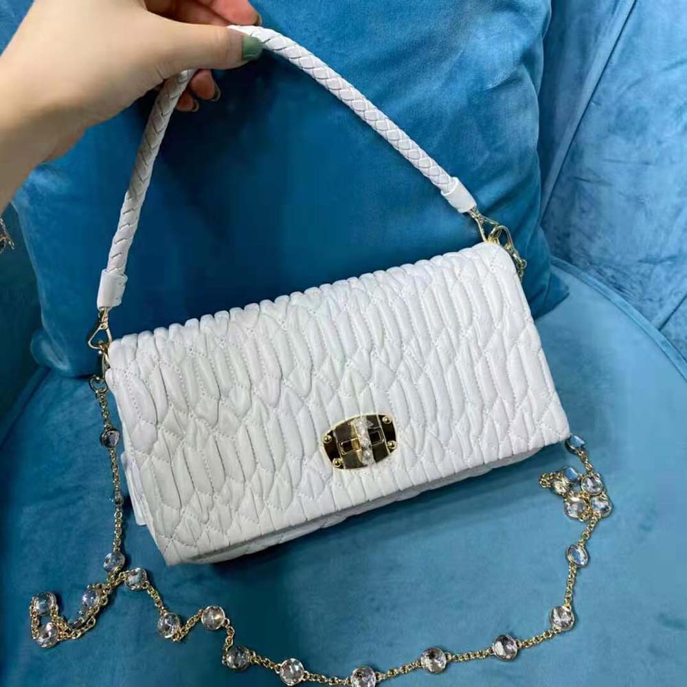 Close-up of crystal flap closure on Miu Miu Women Crystal Cloqué Nappa Leather Bag