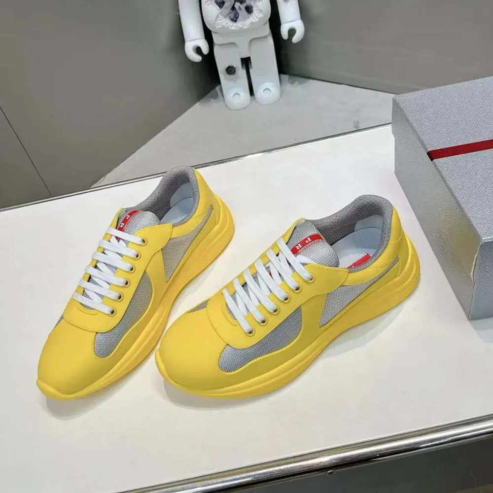 Close-up of yellow bike fabric and rubber details on Prada sneakers