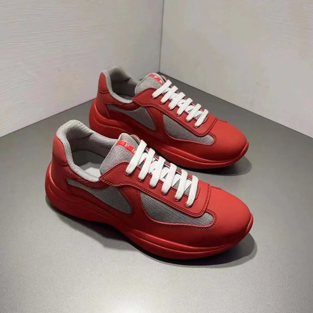Close-up of Prada logo hardware on red sneakers