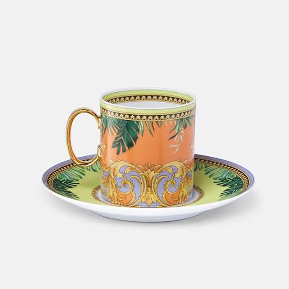 Close-up of Versace coffee cup handle and signature gold Medusa detail
