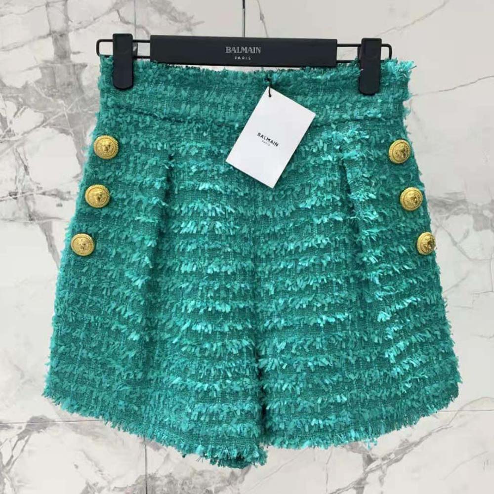 Side angle of Balmain Women Flared Tweed Shorts-Green highlighting fabric texture