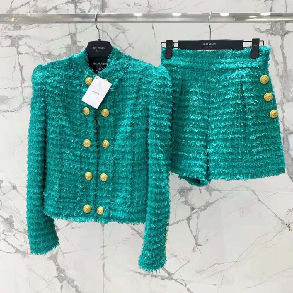 Close-up of fringed detailing and gold buttons on Balmain jacket