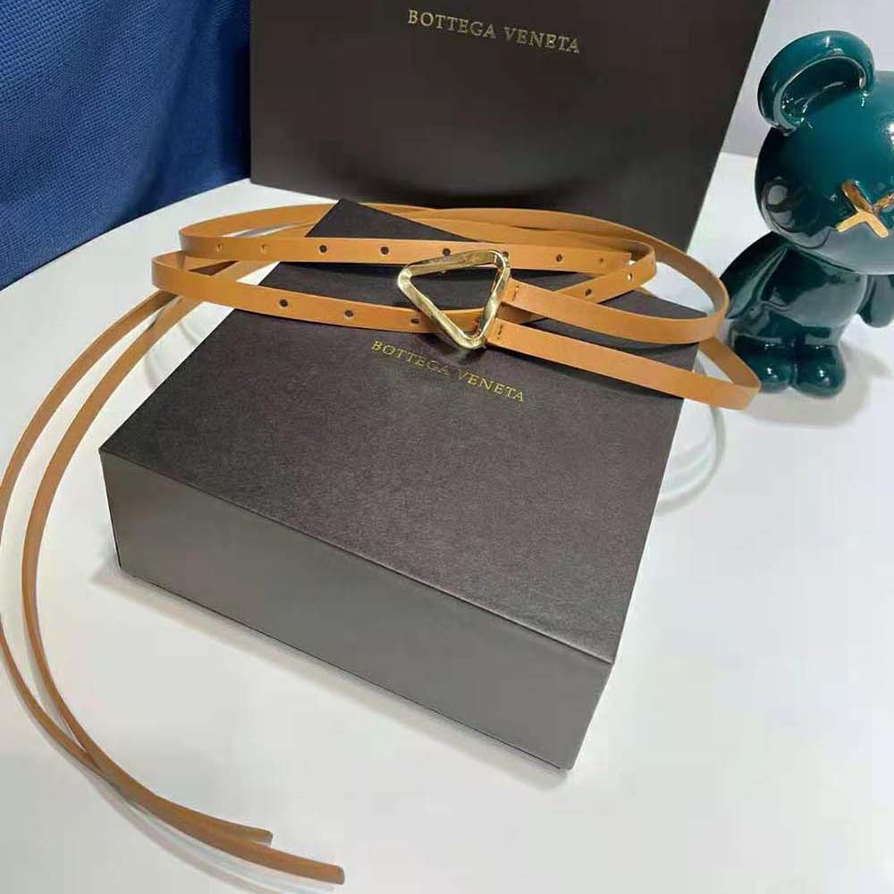 Close-up of gold-tone buckle and double strap on Bottega Veneta belt