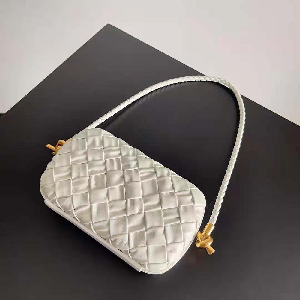 Side angle showcasing silver hardware and detachable strap