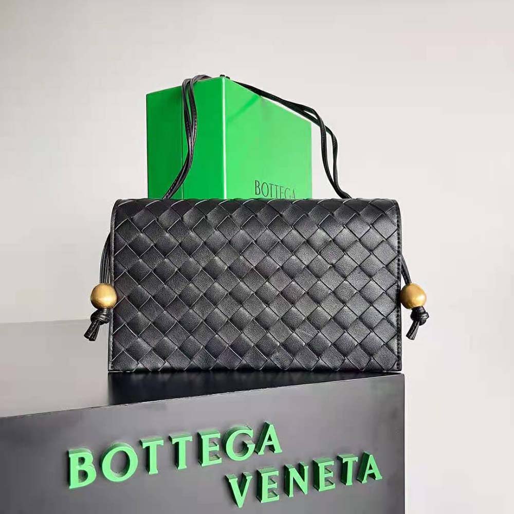 Close-up of black intrecciato leather texture on Bottega Veneta Women Trio Pouch On Strap