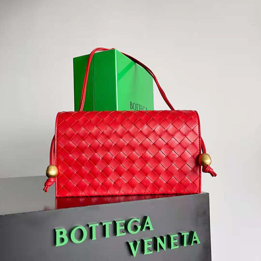 Close-up of red intrecciato leather texture and silver hardware details