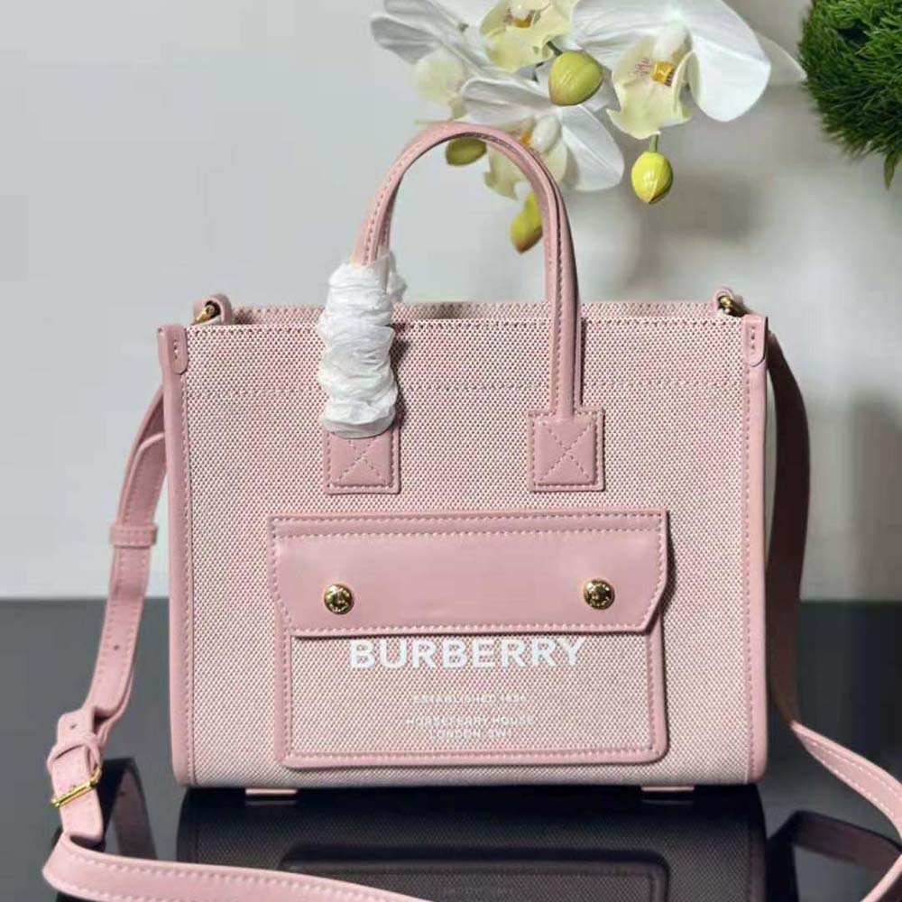 Side angle showing compact silhouette of Burberry Women Mini Freya Tote-Pink