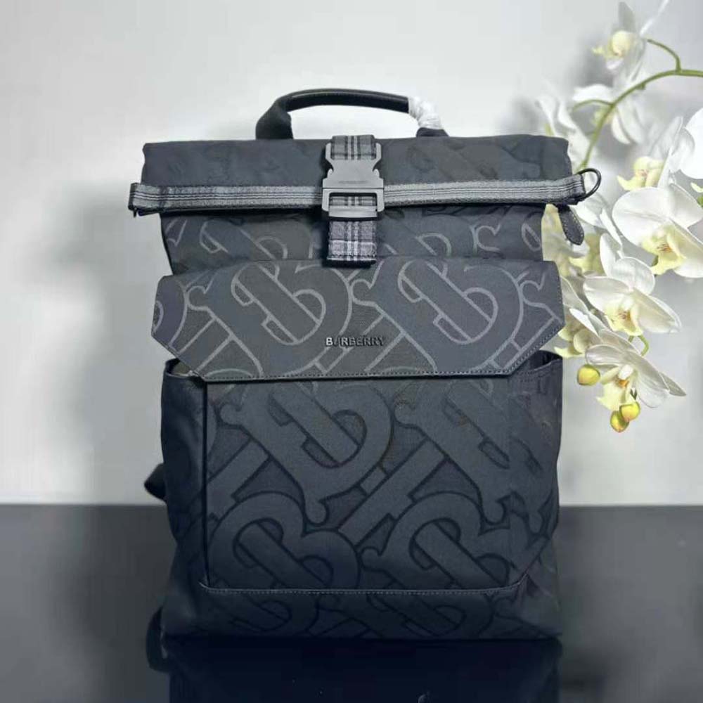 Close-up of raised Burberry lettering on black leather backpack