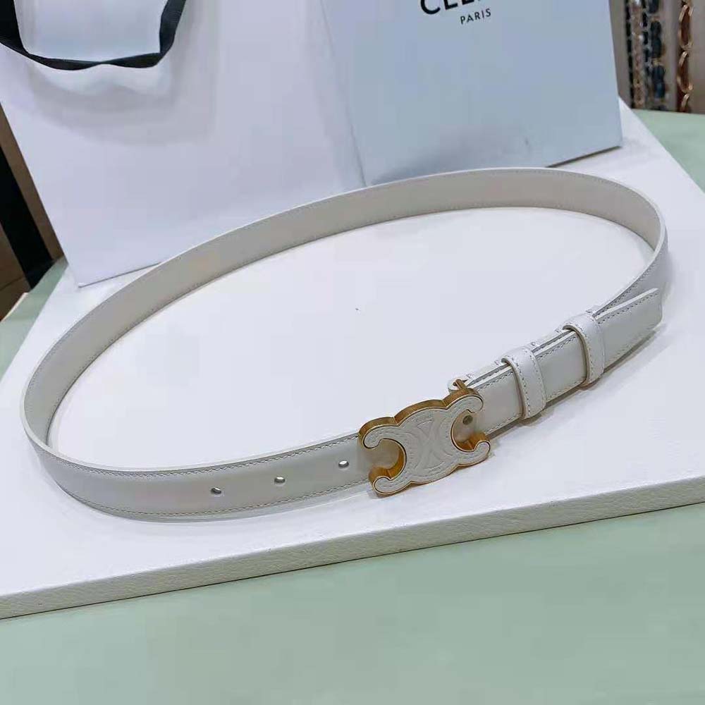 Close-up of gold-tone Triomphe buckle on white Celine belt
