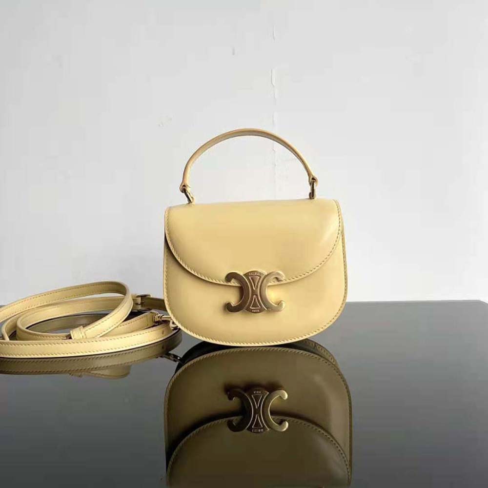 Close-up of gold Triomphe clasp on yellow Celine Women Mini Besace Triomphe