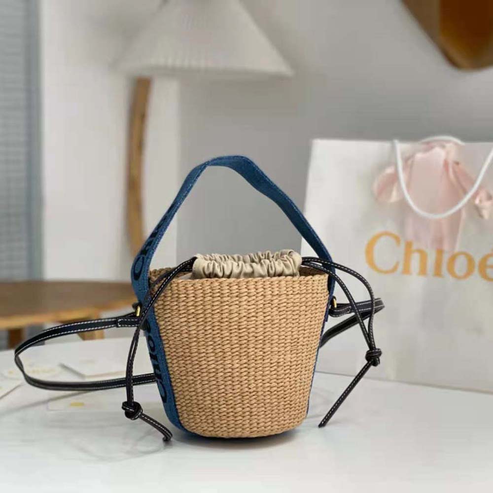 Close-up of navy leather trim and gold hardware on Chloe Women Small Woody Basket-Navy