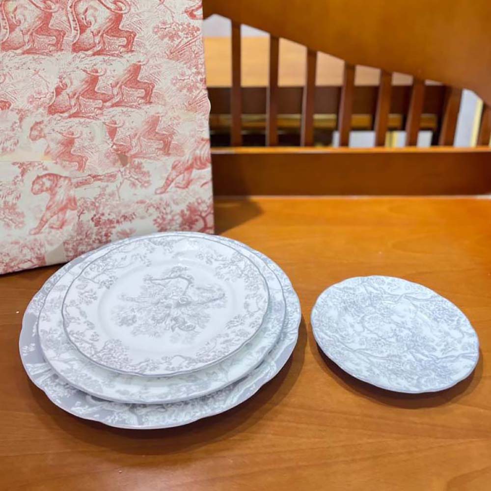 Side angle showing shape and fine porcelain of Dior dessert plate
