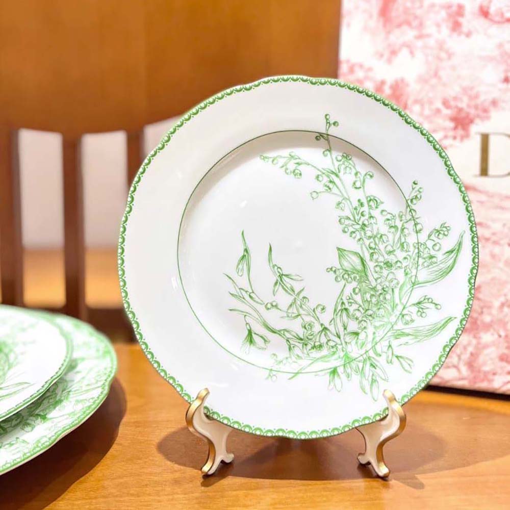 Close-up of green floral motif on Dior dessert plate