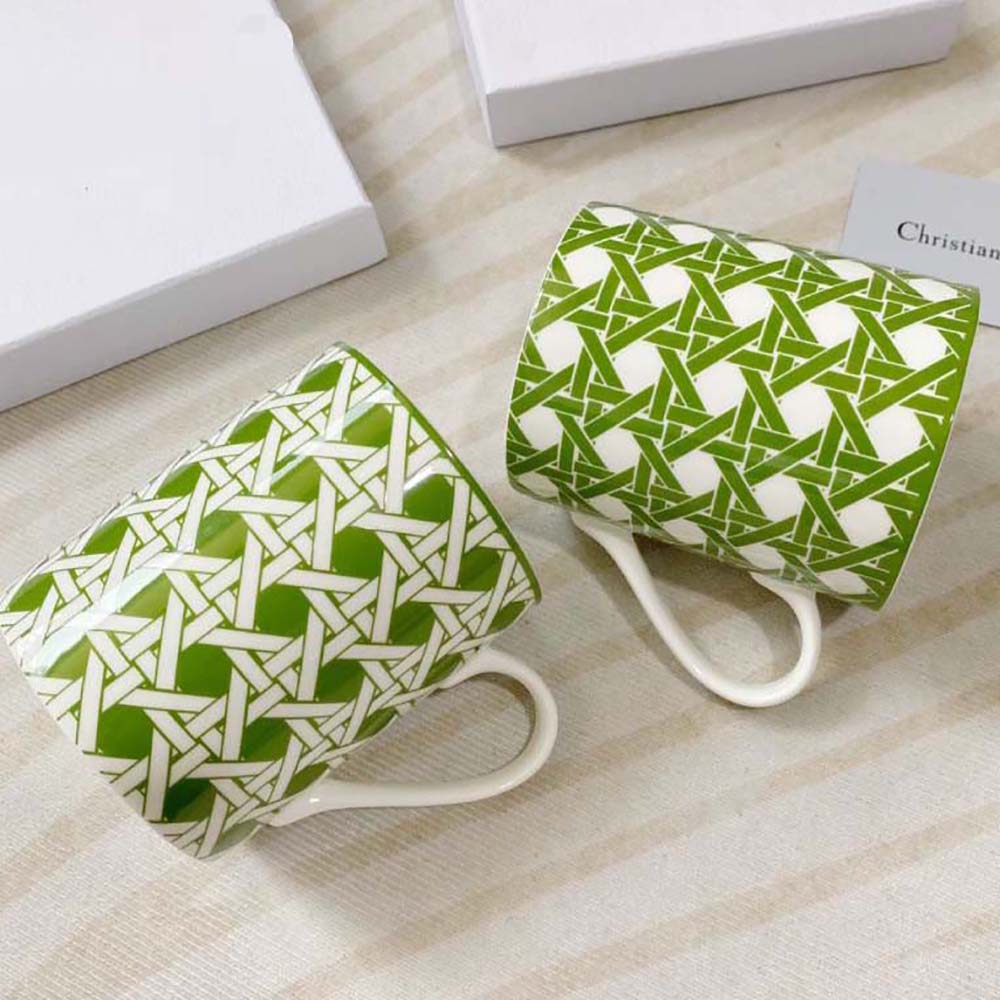 Close-up detail of the green Cannage pattern on Dior mugs