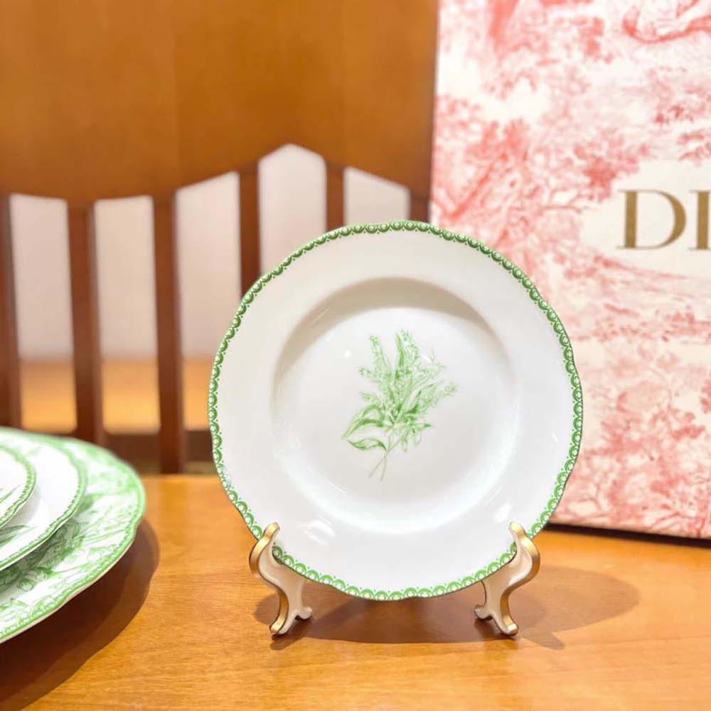 Close-up of signature Dior hardware on side plate in green