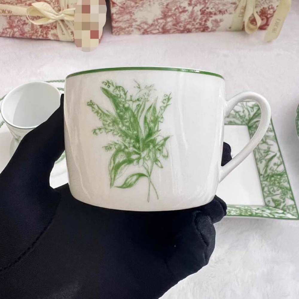 Close-up detail of signature Lily of the Valley charm on Dior Teacup