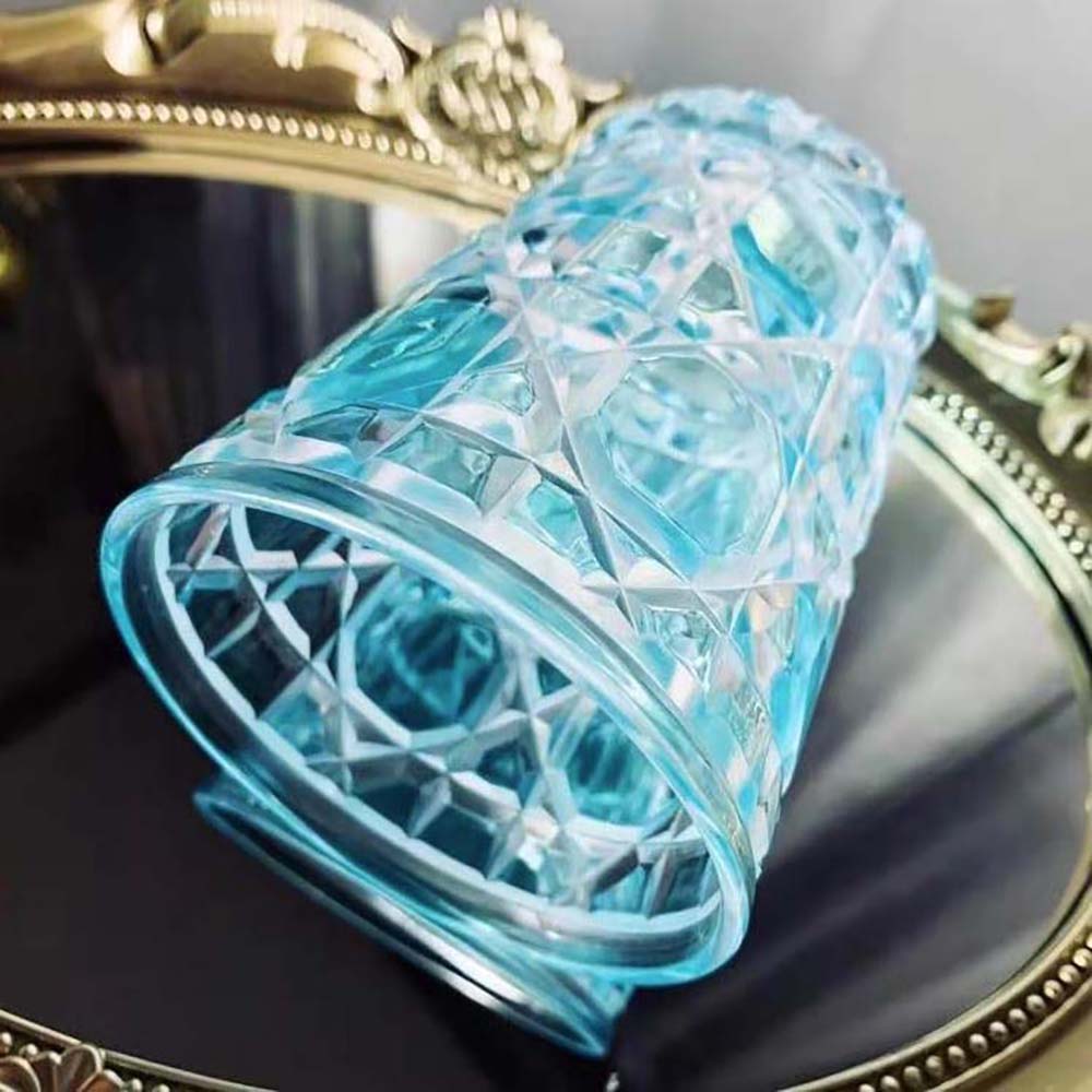 Close-up of embossed Cannage detail on Dior Unisex Water Glass Aquamarine Cannage