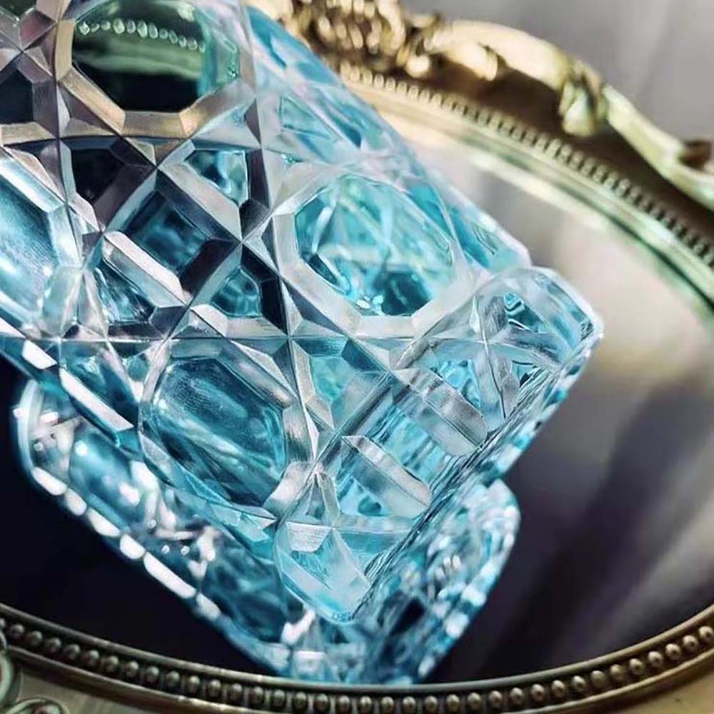 Angled shot of Dior Unisex Water Glass Aquamarine Cannage highlighting etched logo base