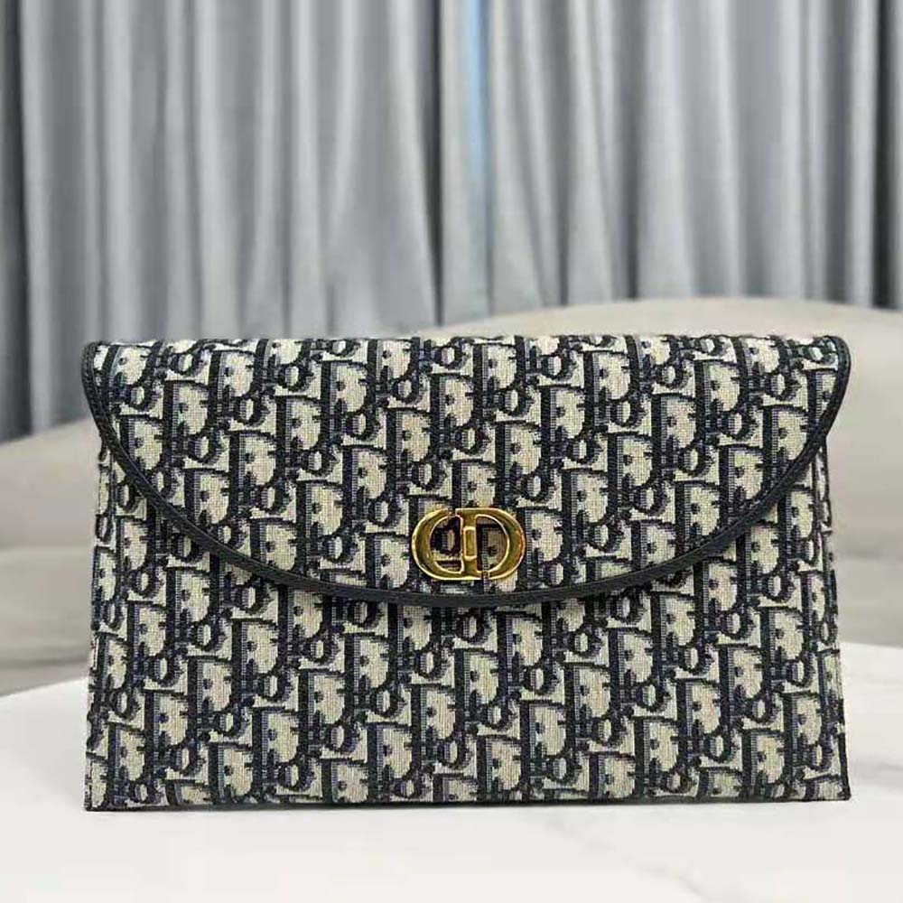 Side angle showing compact silhouette of Dior Women 30 Montaigne Avenue Pouch in blue