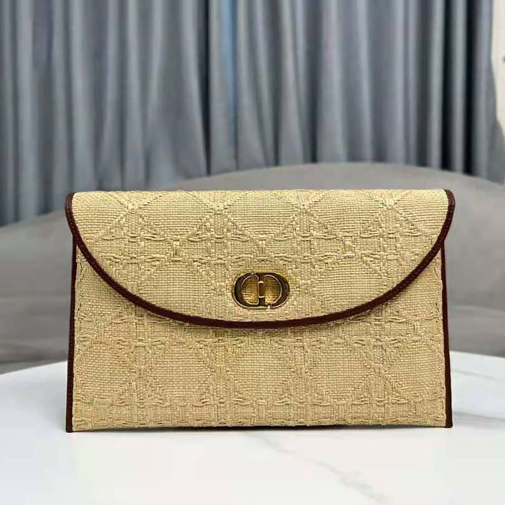Side angle showing gold hardware detail on Dior raffia pouch