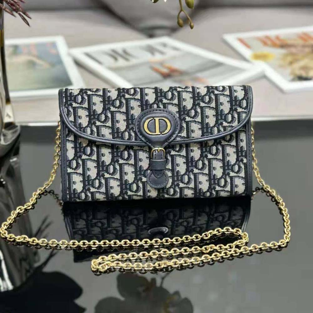 Close-up detail of blue Dior Oblique jacquard fabric and silver chain