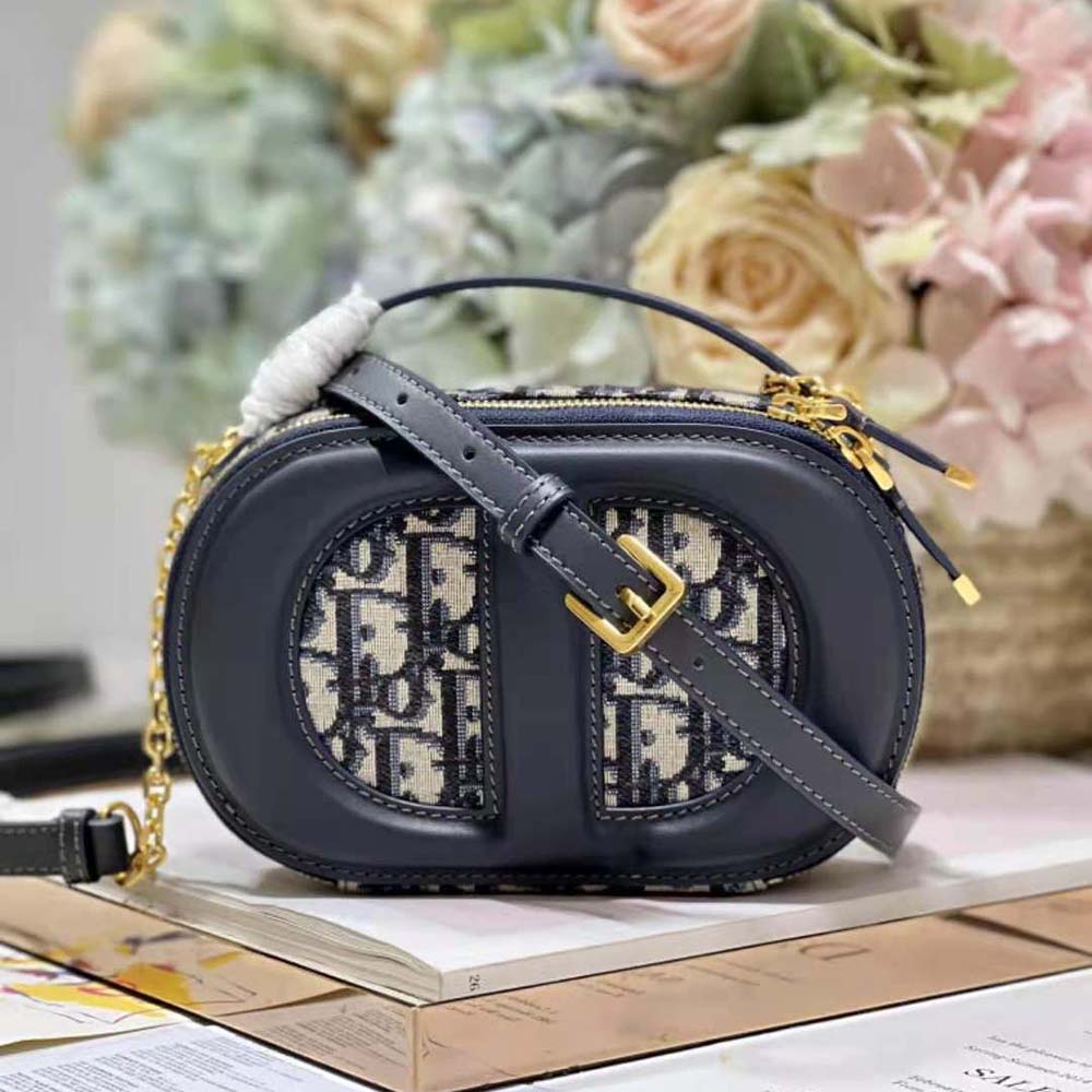 Close-up of silver-tone CD hardware on Dior Women CD Signature Oval Camera Bag