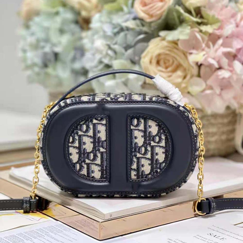 Side angle showing zip closure and leather pull on Dior Women CD Signature Oval Camera Bag