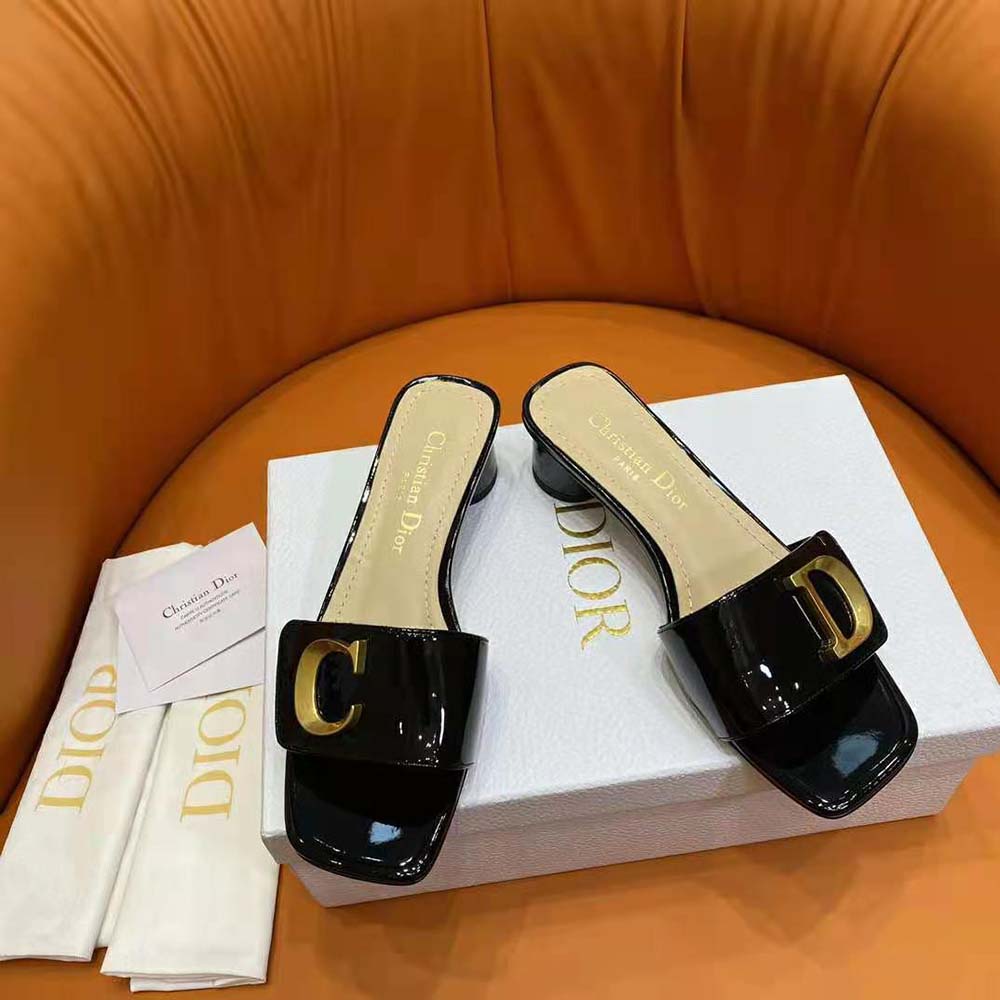 Close-up on branded silver Dior hardware detail on the heeled slide