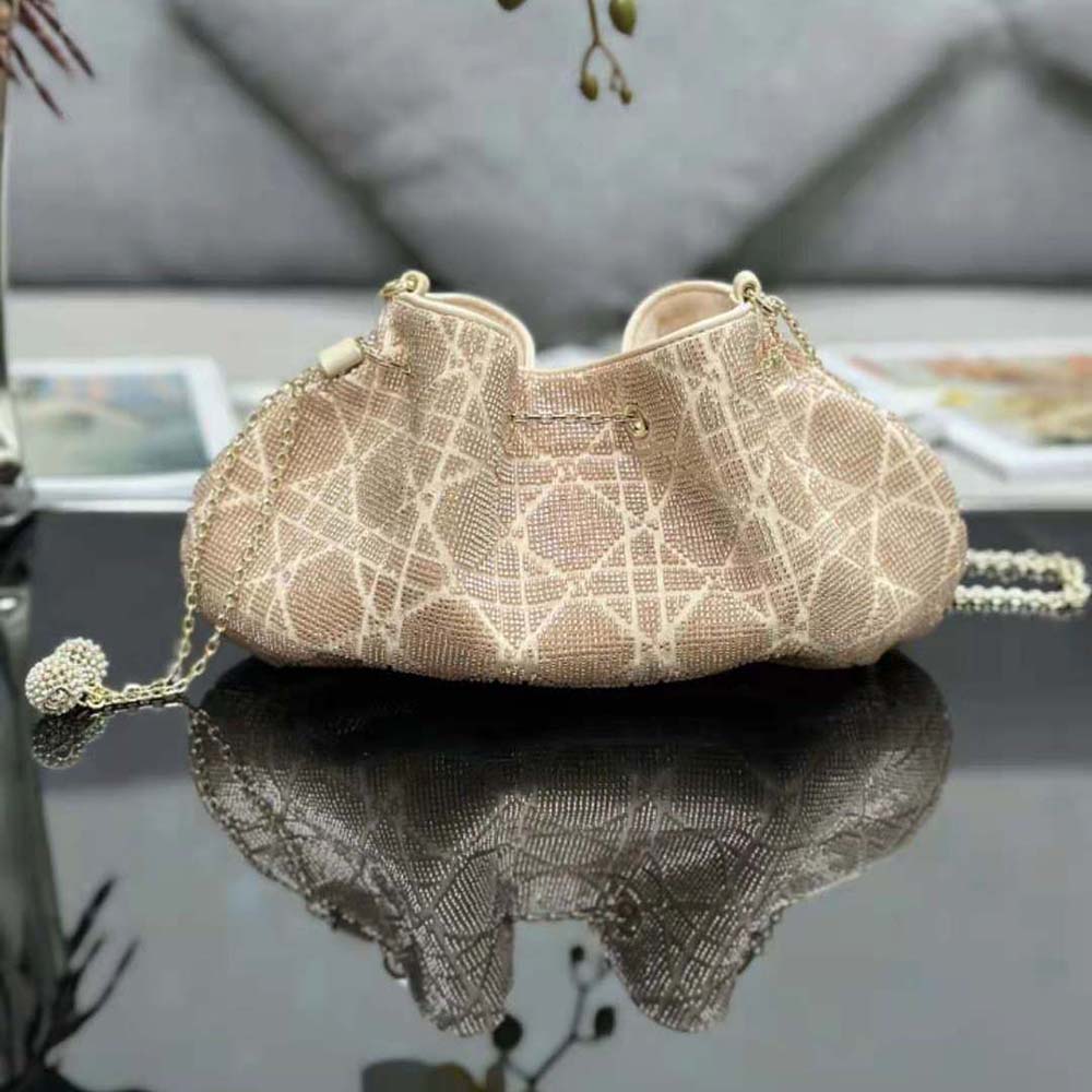Side profile showing silver hardware and drawstring closure on Dior Bucket Bag