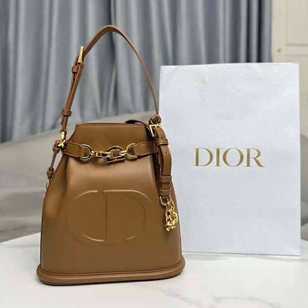 Close-up of golden CD hardware on Dior Women Medium C’est Dior Bag