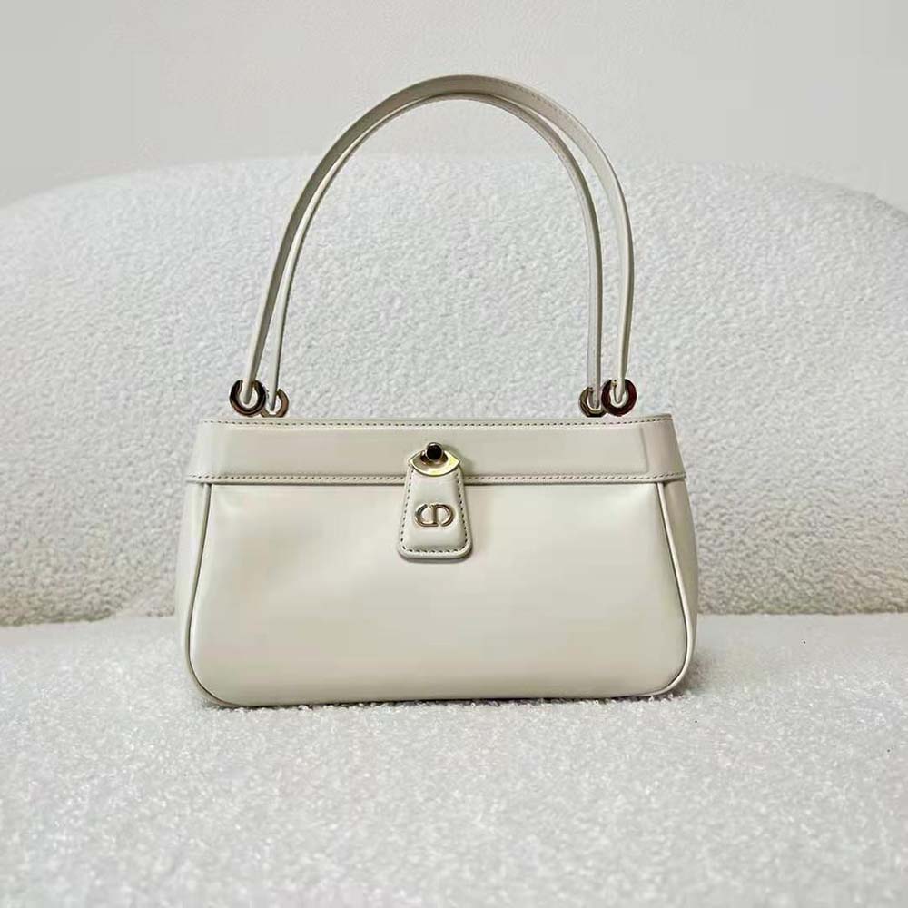 Close-up of silver Dior charm hardware on key bag