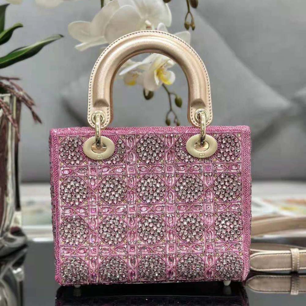 Side angle showing metallic calfskin texture and flap closure of Dior Women Small Lady Dior Bag