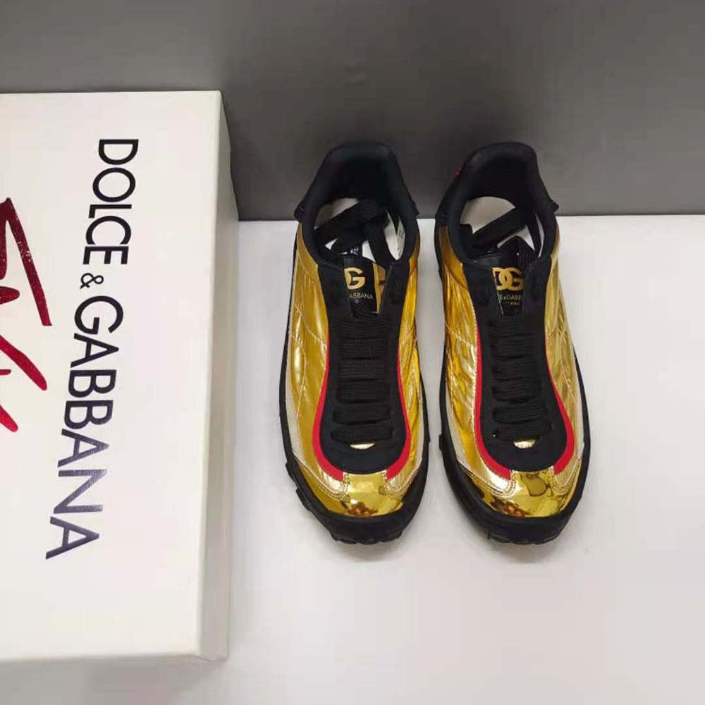 Close-up of gold finish and embossed D&G hardware on sneakers