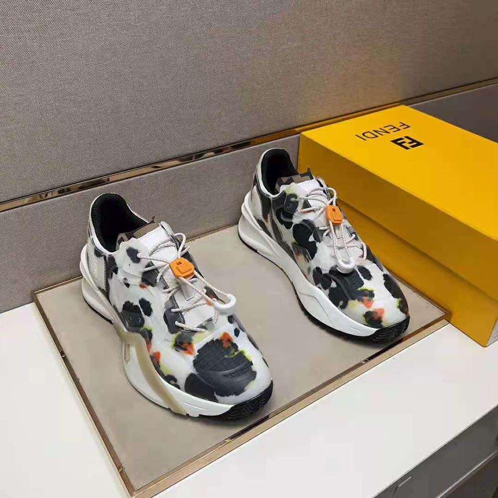 Close-up of Fendi logo hardware on black low-tops