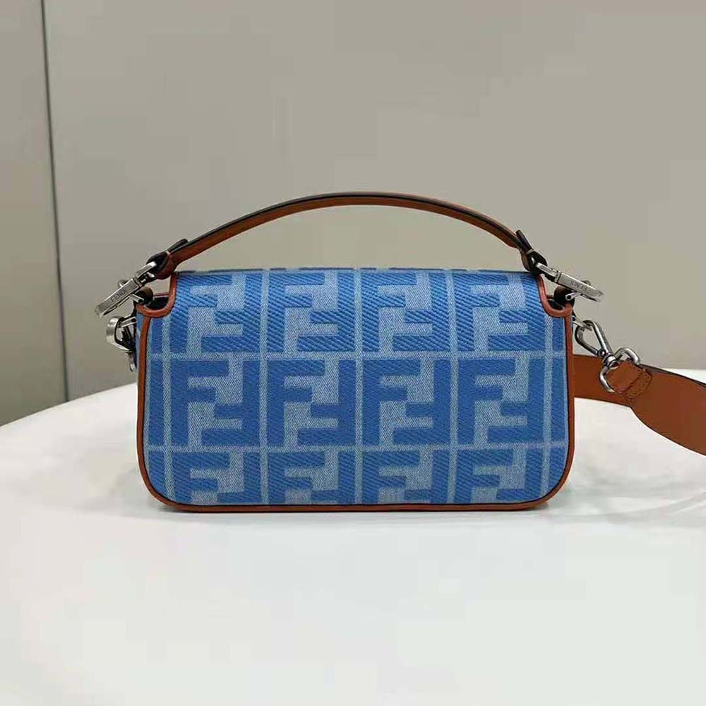 Side angle of Fendi Women Baguette Light Blue Denim Bag with magnetic flap