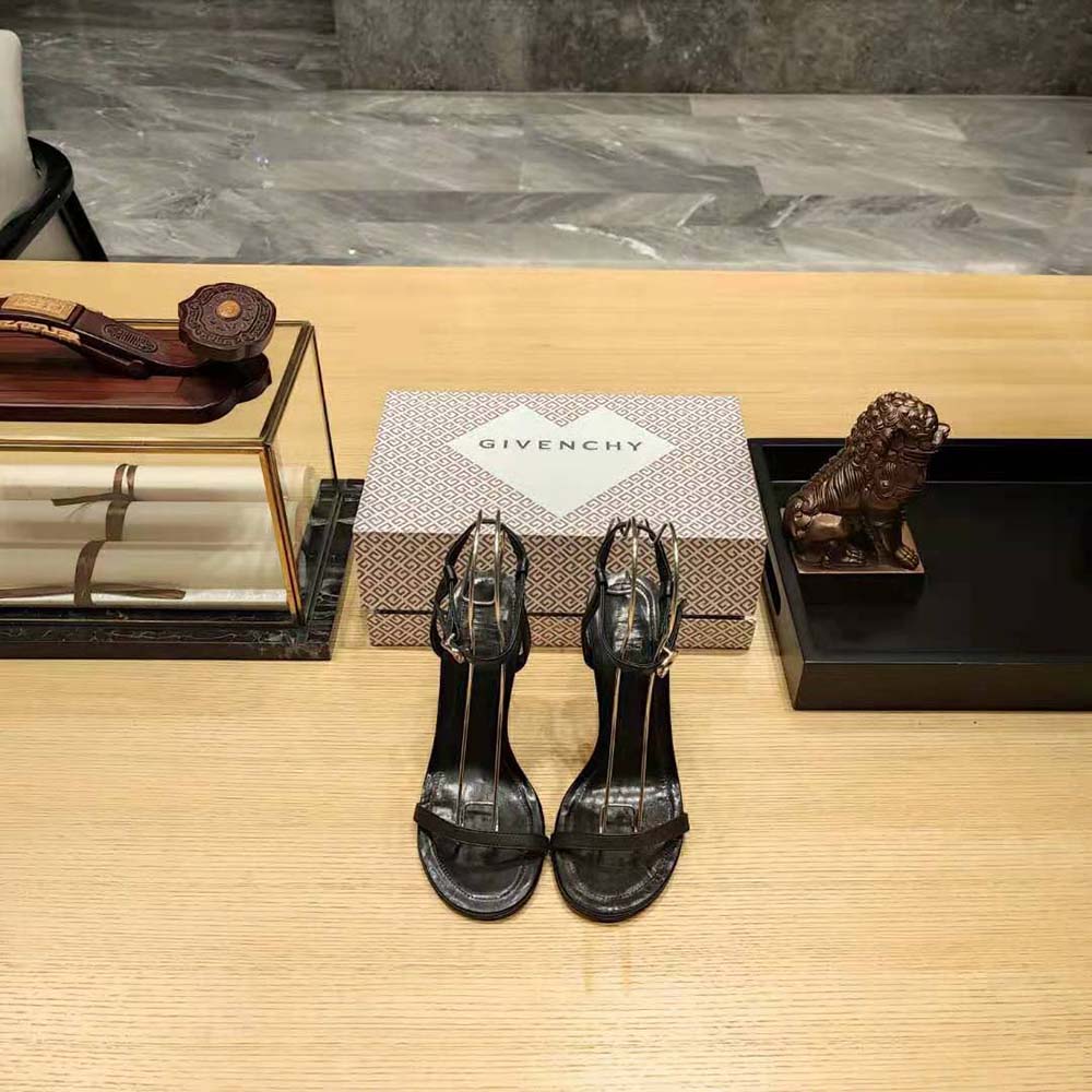 Close-up of black leather and G Cube hardware on Givenchy sandals